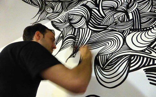 Close-up of artist KEF! painting live at Genesis Cinema