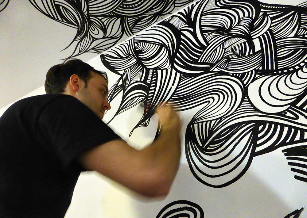 Close-up of artist KEF! painting live at Genesis Cinema